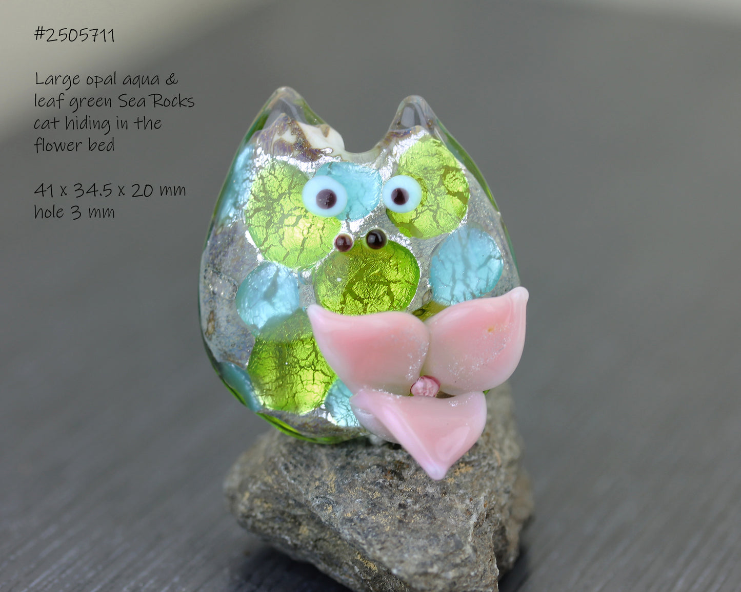 Lampwork glass floral cat bead in green, blue and pink with metllic sparkle