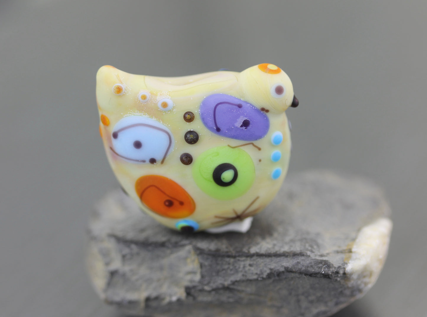 Pale pastel yellow Miro lampwork glass bird bead