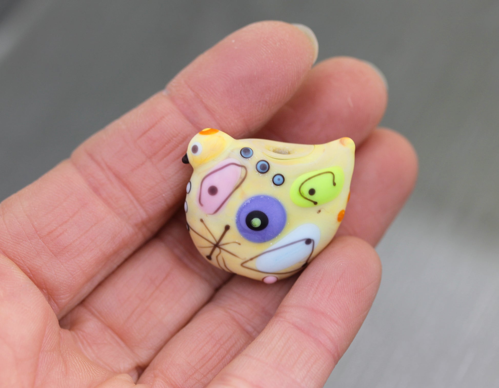 Pale pastel yellow Miro lampwork glass bird bead