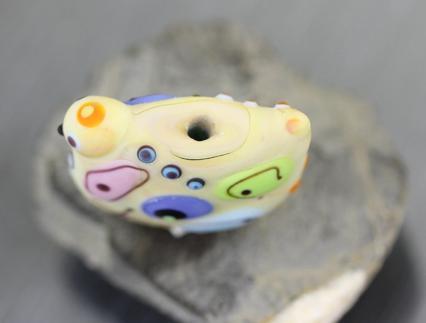 Pale pastel yellow Miro lampwork glass bird bead