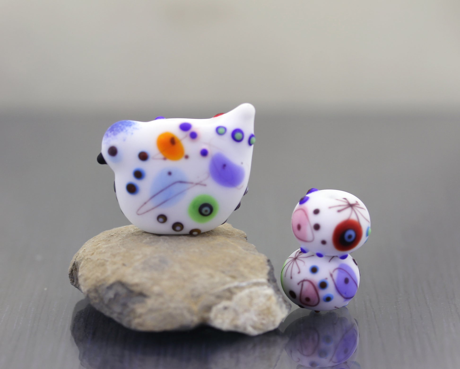 etched white bird lampwork glass beads with a fun colorful pattern