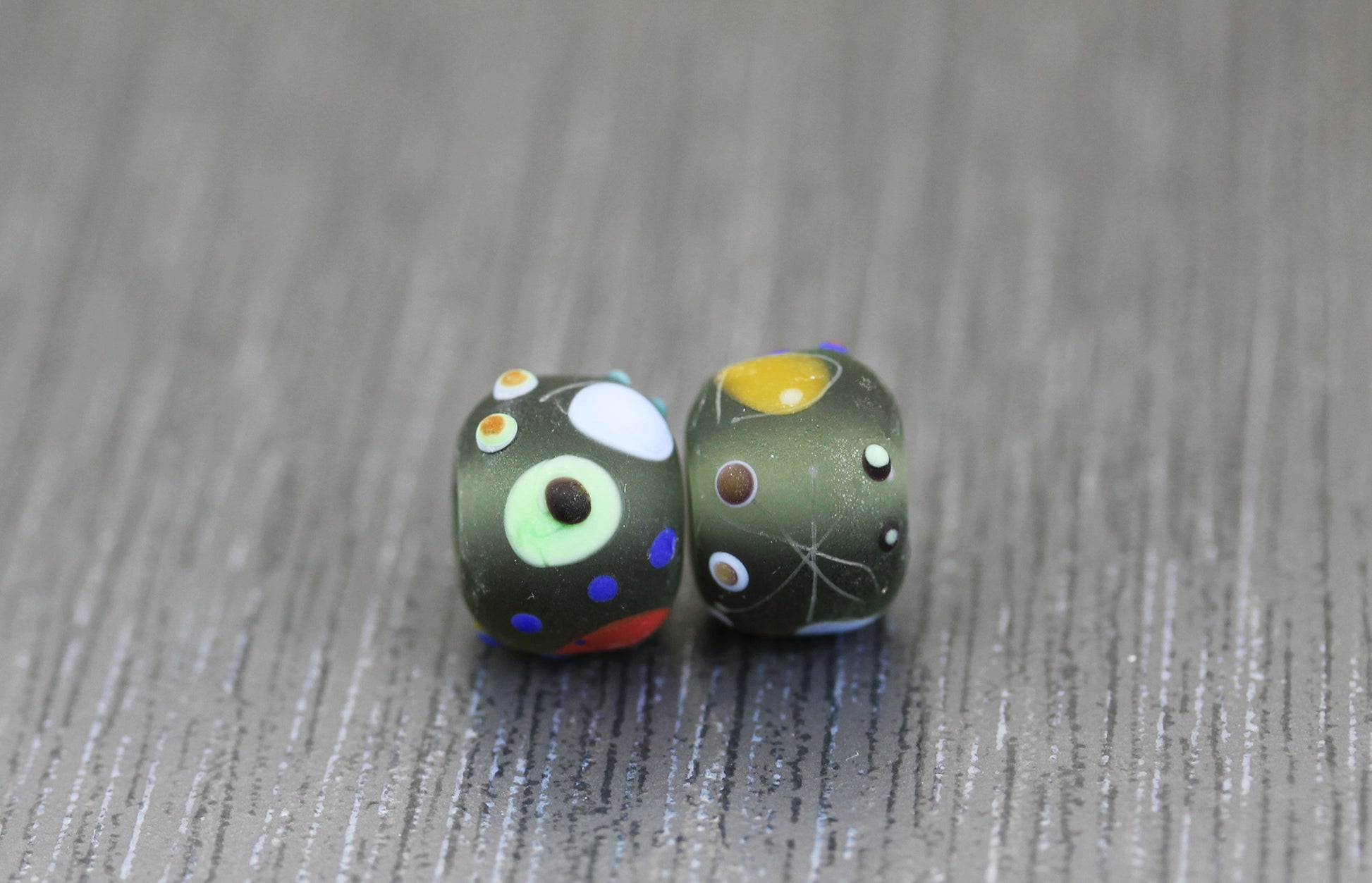 matte etched granslucent gray lampwork glass bead pair with Miro pattern by Anne Londez