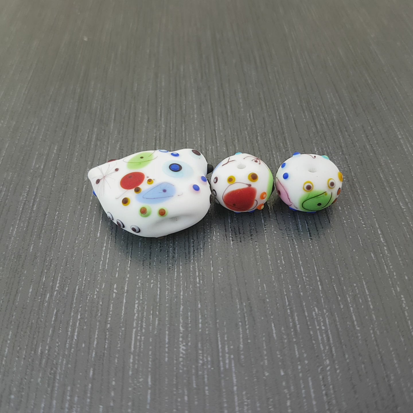 etched white bird lampwork glass beads with a fun colorful pattern